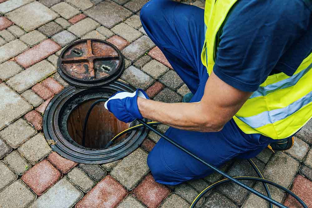 technician hydro jetting a drain